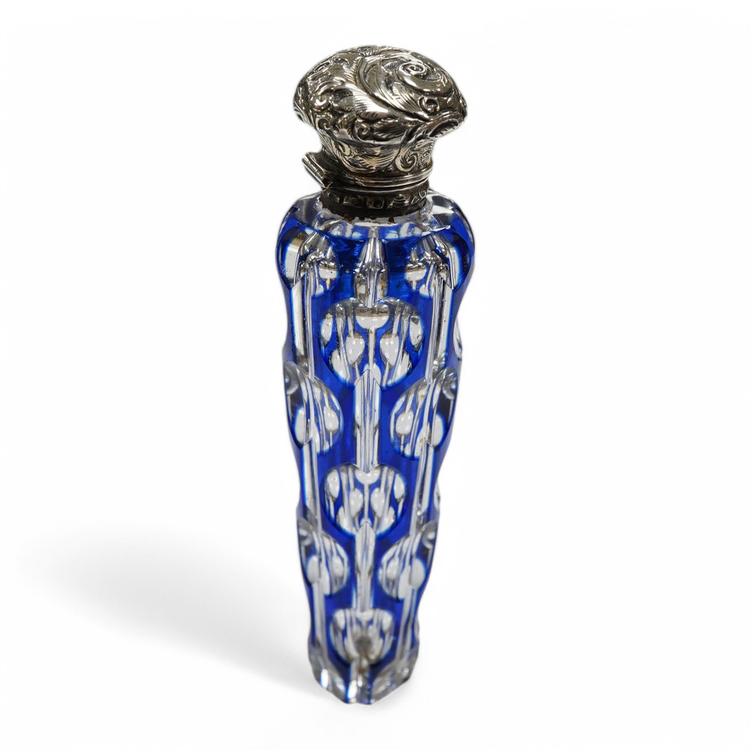 A 19th century silver topped blue overlay glass scent bottle, 11cm long. Condition - fine chips to base